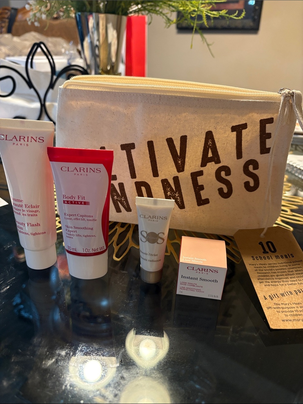 Clarins Skincare Set with Beige Canvas Pouch and Red-Accented Tubes